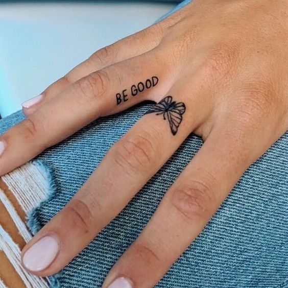 Small butterfly tattoo on finger for female