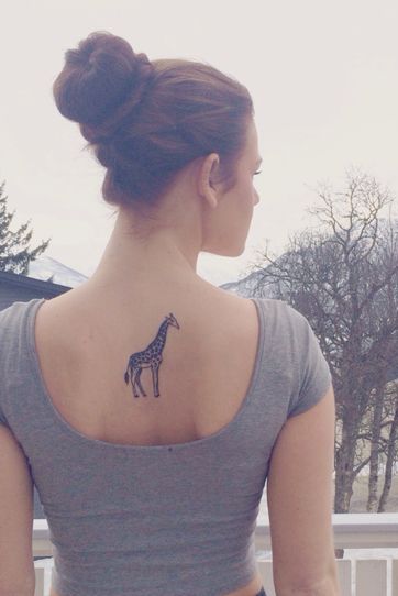giraffe small tattoo on girl back