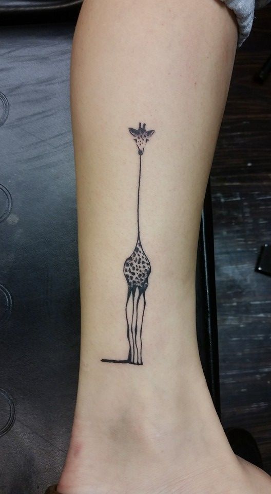 Giraffe tattoo on arm