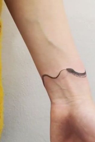 small snake tattoo on wrist