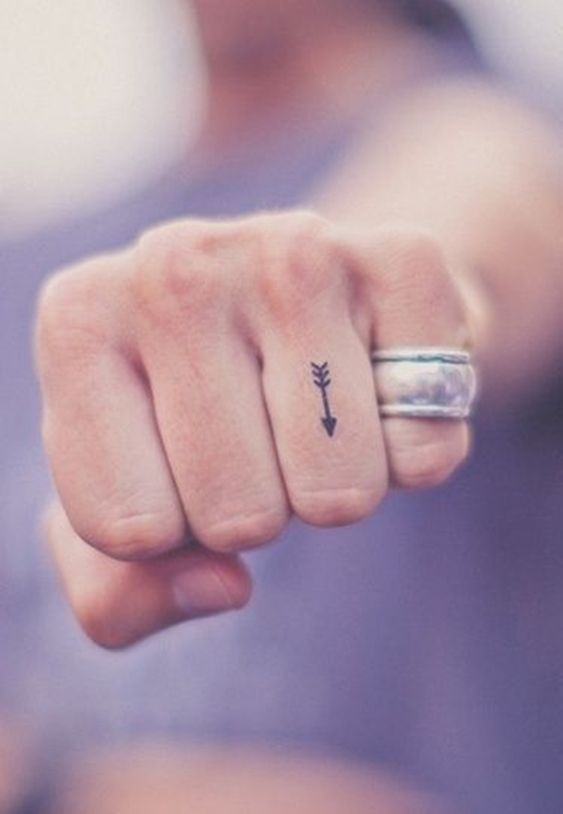 Arrow tattoo on finger