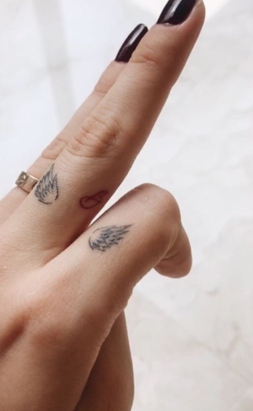 wings tattoo on finger