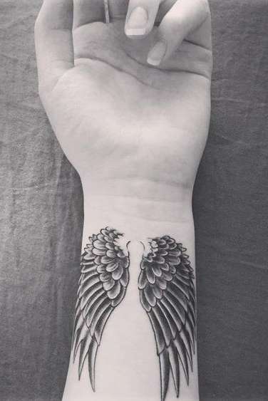 angel wings tattoo on wrist for womens