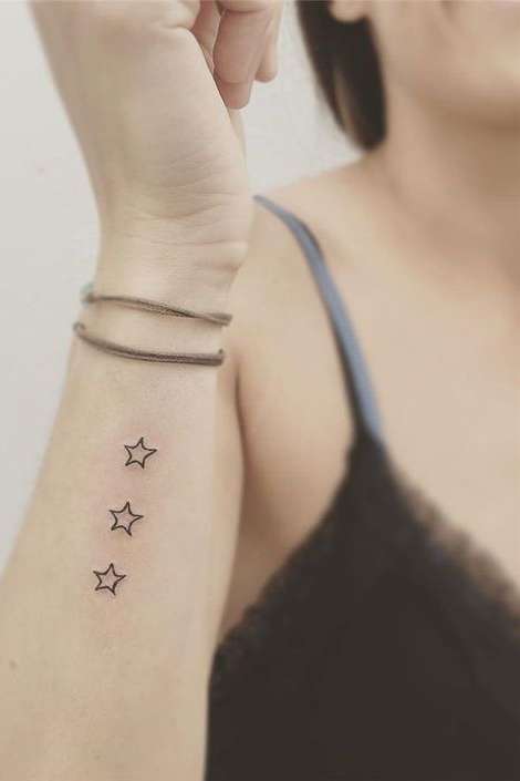 star tattoo on side wrist