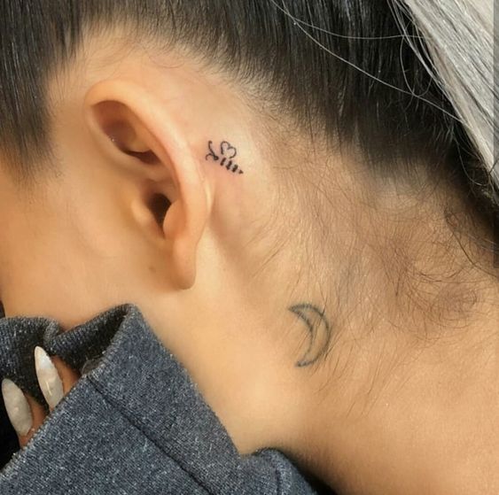 ariana grande moon tattoo on neck