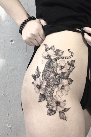 Tiger and flower tattoo on thigh