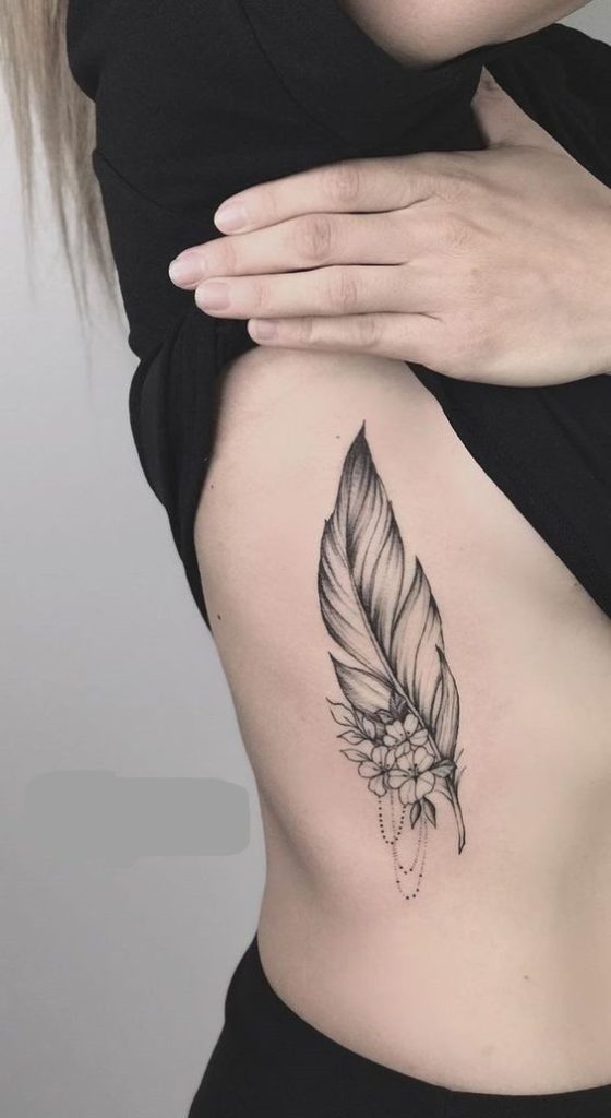 feather tattoo on rib