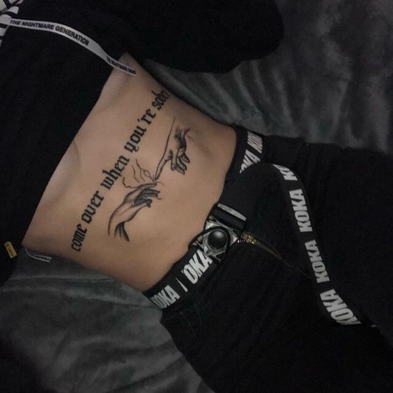 small hand tattoo on stomach