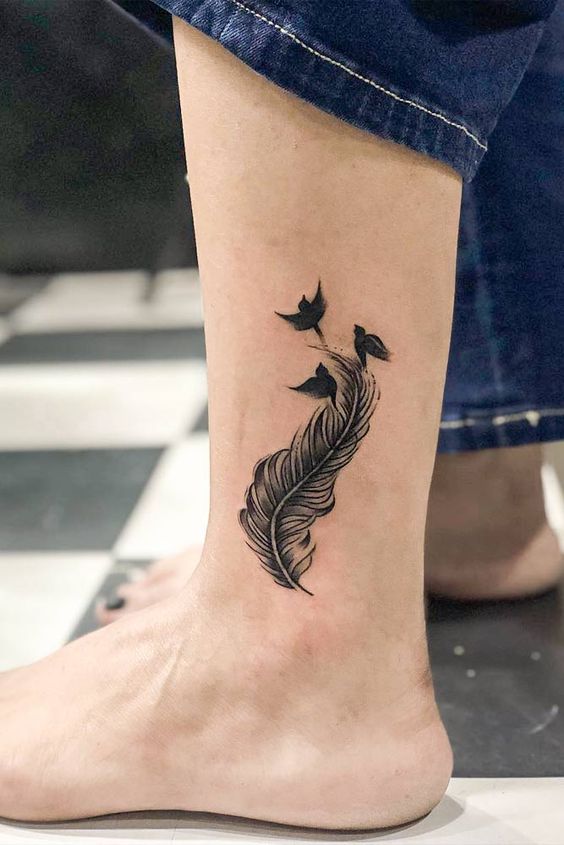 feather tattoo on leg