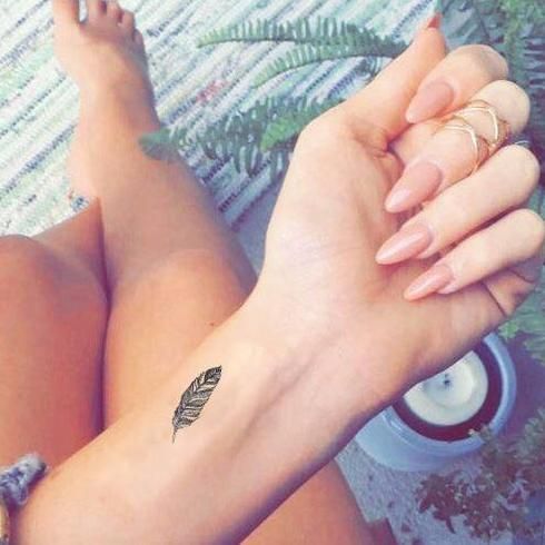 feather tattoo on wrist for women