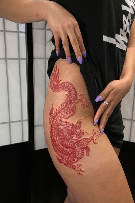 red dragon tattoo on thigh