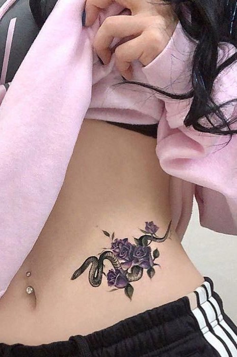 small snake tattoo on stomach