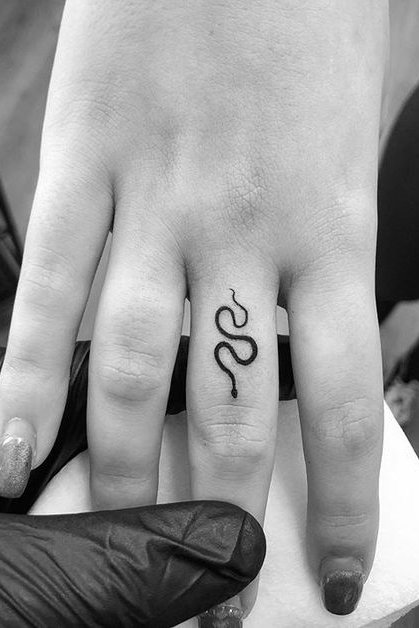 small snake tattoo on finger