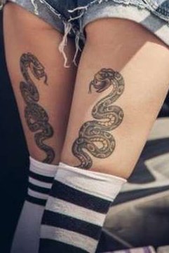 small snake tattoo on back thigh