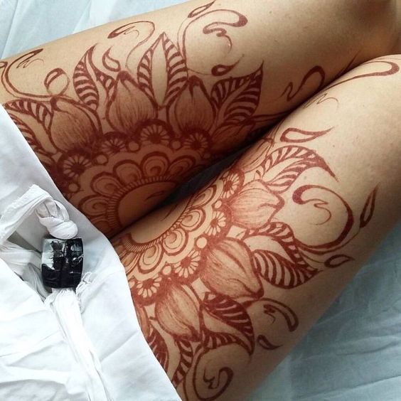cute orange henna tattoo on thigh