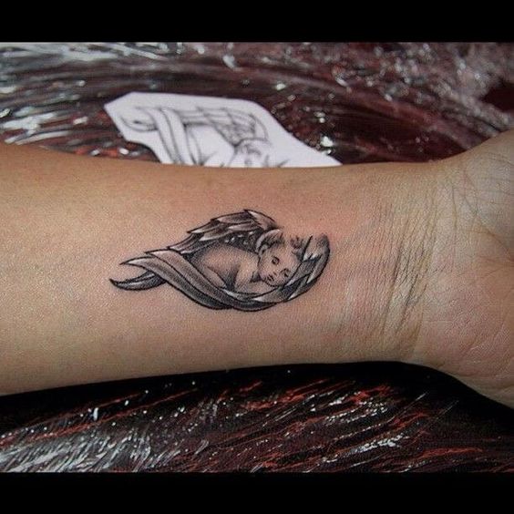 Angel tattoo on wrist