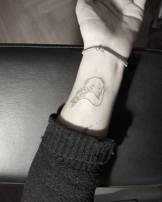 Angel tattoo on wrist