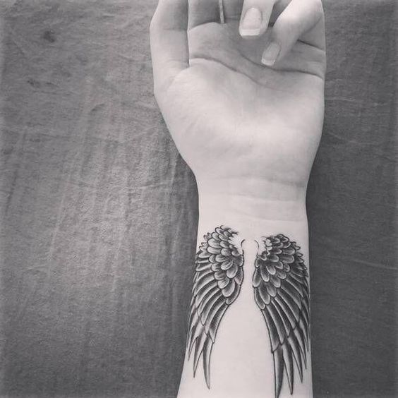 Angel wings tattoo on wrist
