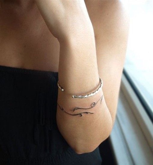 Bracelet tattoos on arm