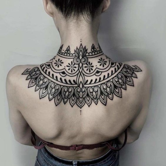 unique design upper back tattoo