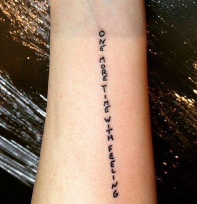 “One More Time With Feelings” on her forearm